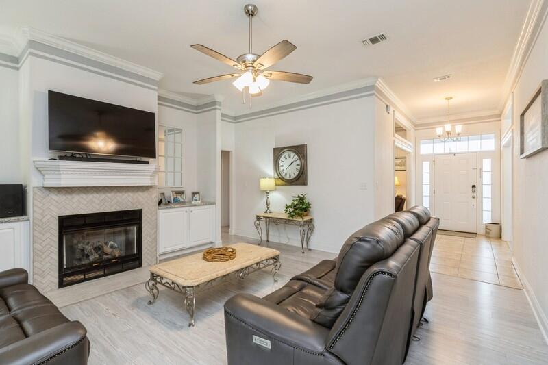 2903 Chancery Lane Crestview, FL 32539 - Photo 2 of 43 a living room with furniture a flat screen tv and a fireplace