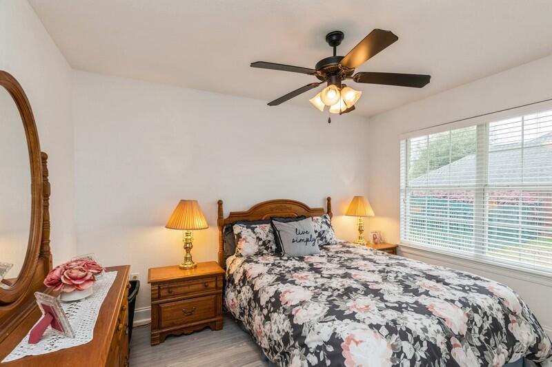 2903 Chancery Lane Crestview, FL 32539 - Photo 22 of 43 a bedroom with a bed and a chandelier