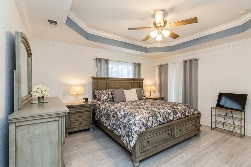 2903 Chancery Lane Crestview, FL 32539 - Photo 27 of 43 a bedroom with a bed and a chandelier