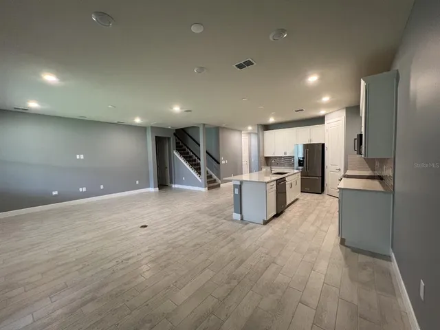 a view of kitchen with cabinets