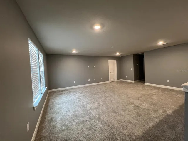 a view of an empty room with windows