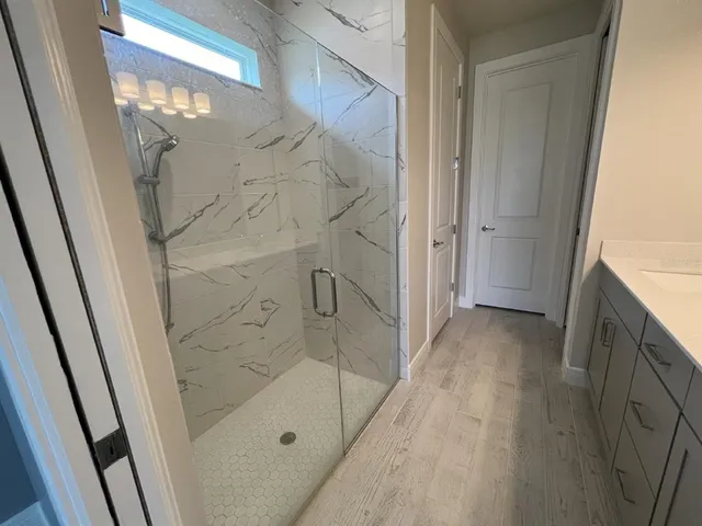 a bathroom with double vanity and a mirror
