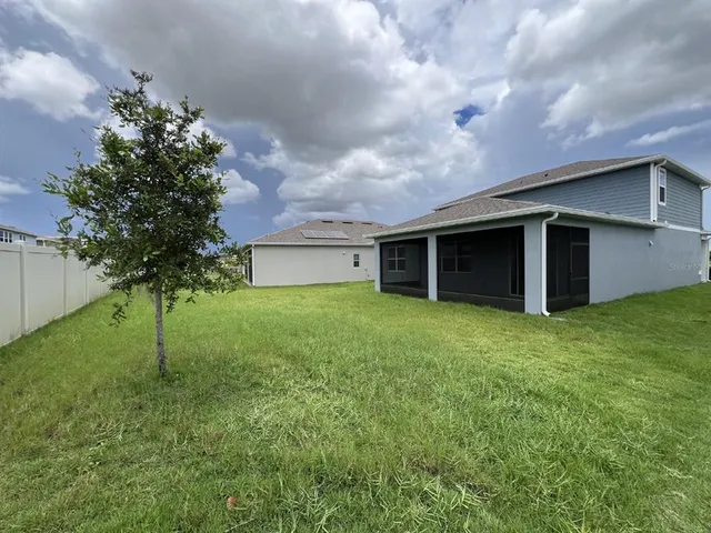 a yellow house with garden in front of it