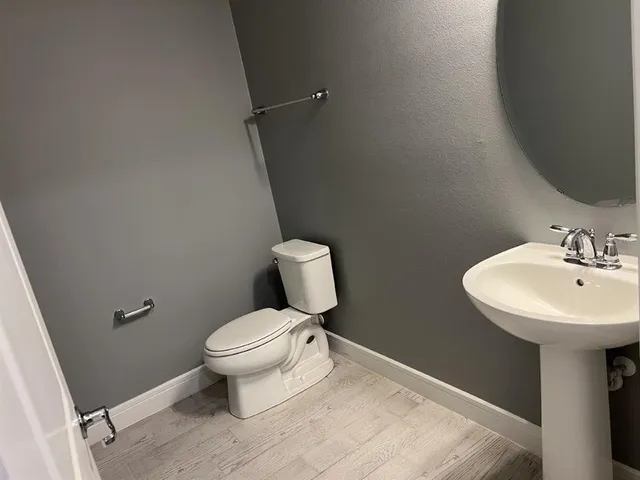 a white toilet sitting next to a bathroom sink
