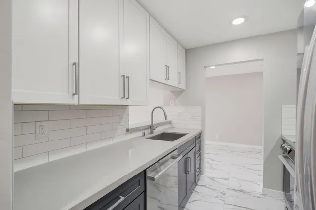 a kitchen with stainless steel appliances a refrigerator and a sink