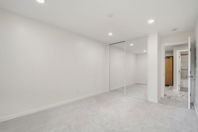 an empty room with windows and pillars in it