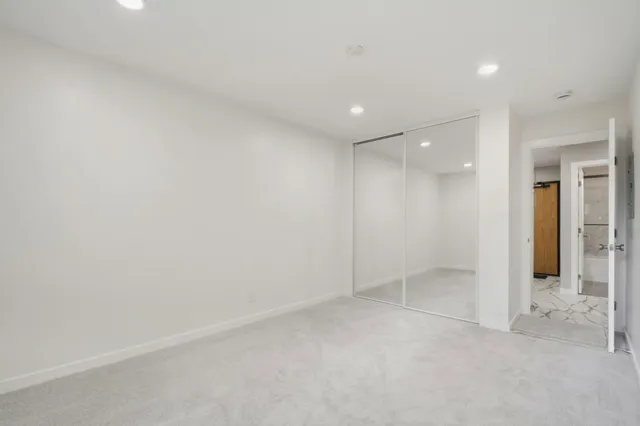 an empty room with windows and pillars in it