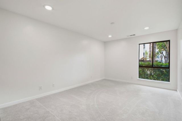 a bathroom with a granite countertop sink toilet and mirror