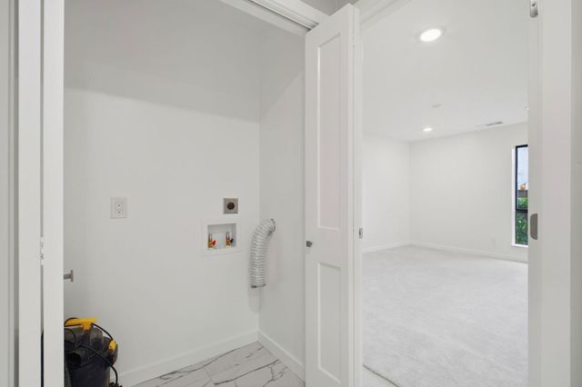 a view of a house with wooden fence next to a yard