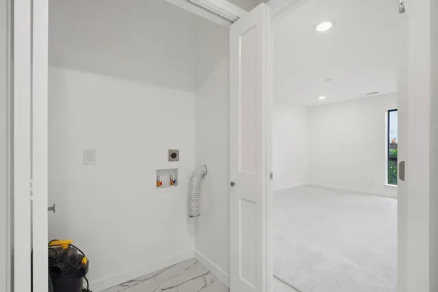 a view of a house with wooden fence next to a yard