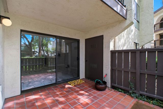 a view of backyard with deck and wooden floor