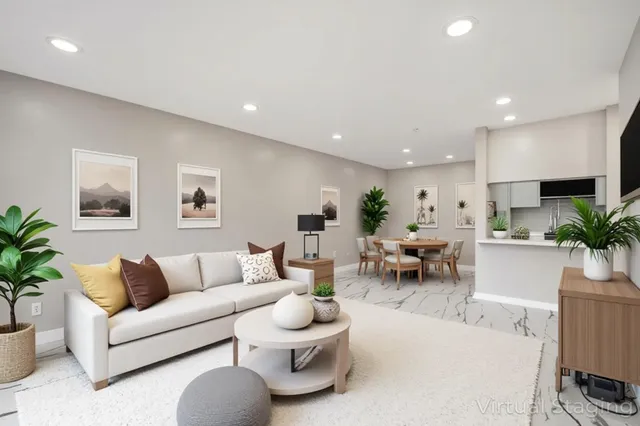 a living room with furniture a rug and a table