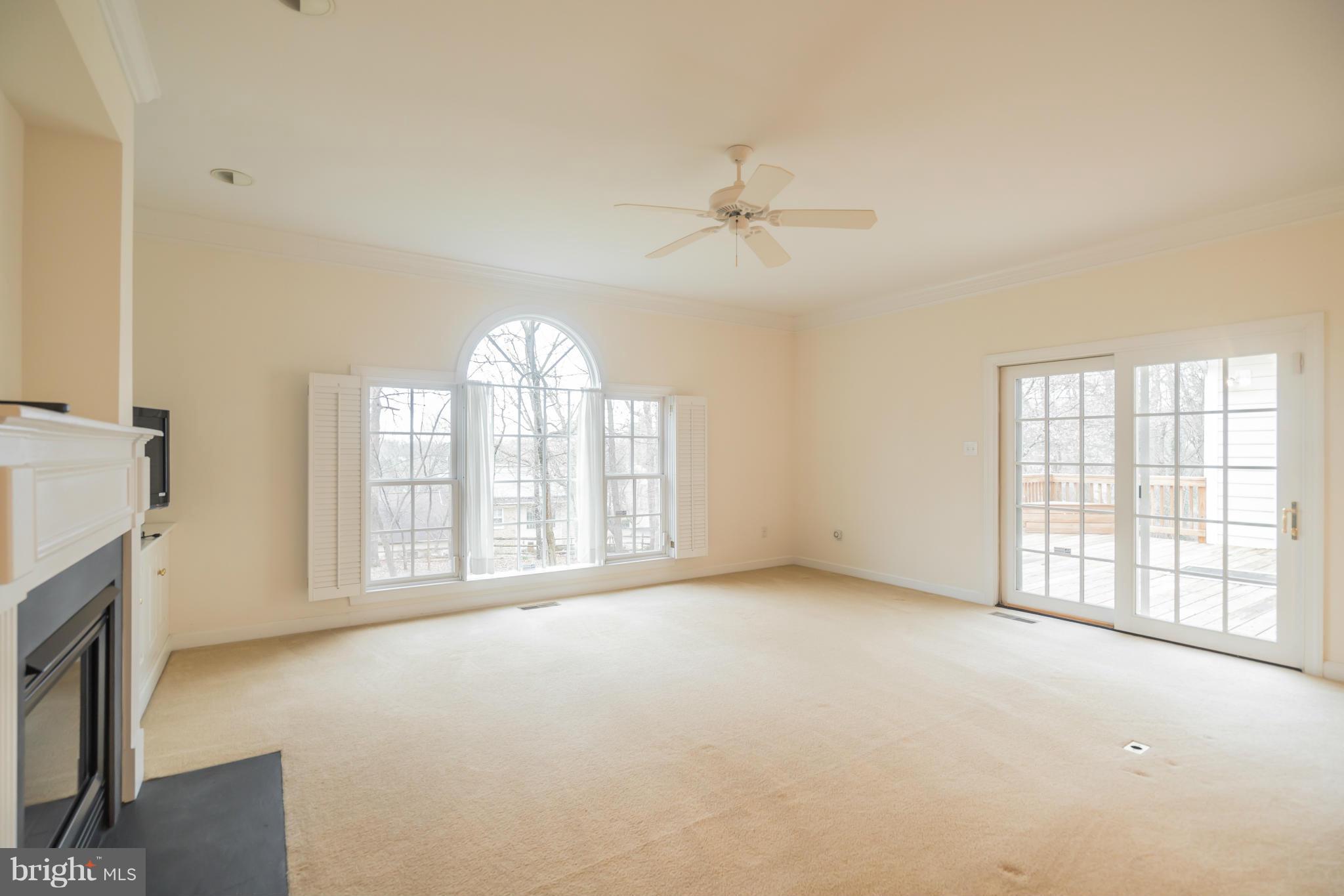 9504 Emory Grove Road Gaithersburg, MD 20877 - Photo 10 of 30 a view of an empty room with a fireplace and a window