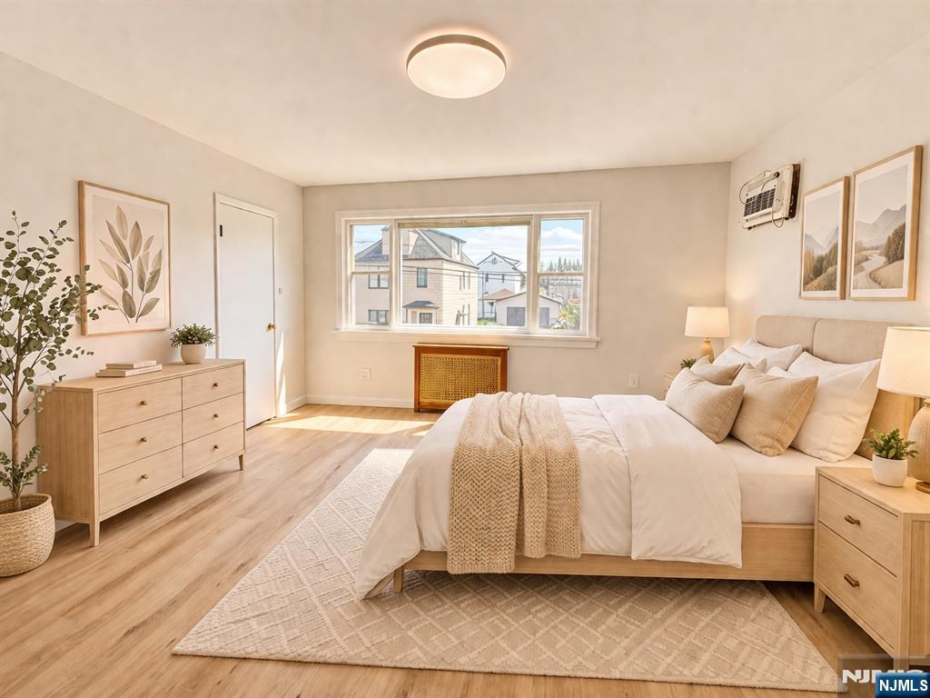 51 Dewitt Street Garfield, NJ 07026 - Photo 6 of 16 a bedroom with a bed and window