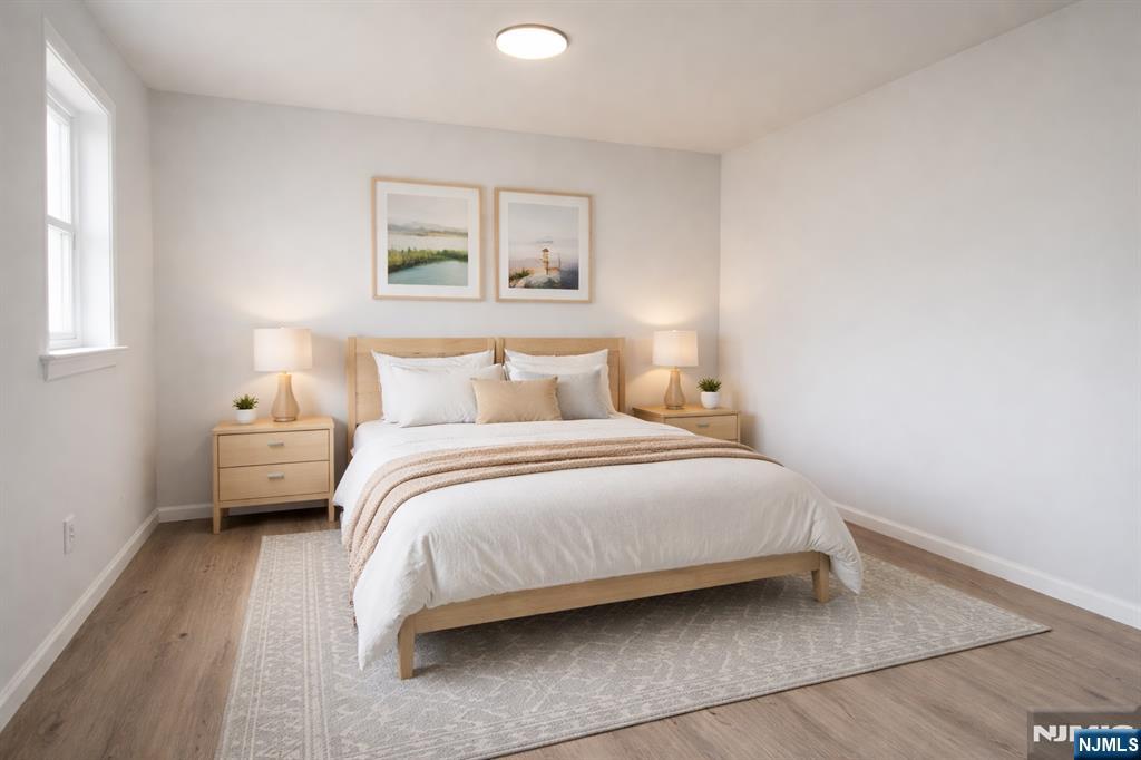 51 Dewitt Street Garfield, NJ 07026 - Photo 10 of 16 a bedroom with a bed and a night stand