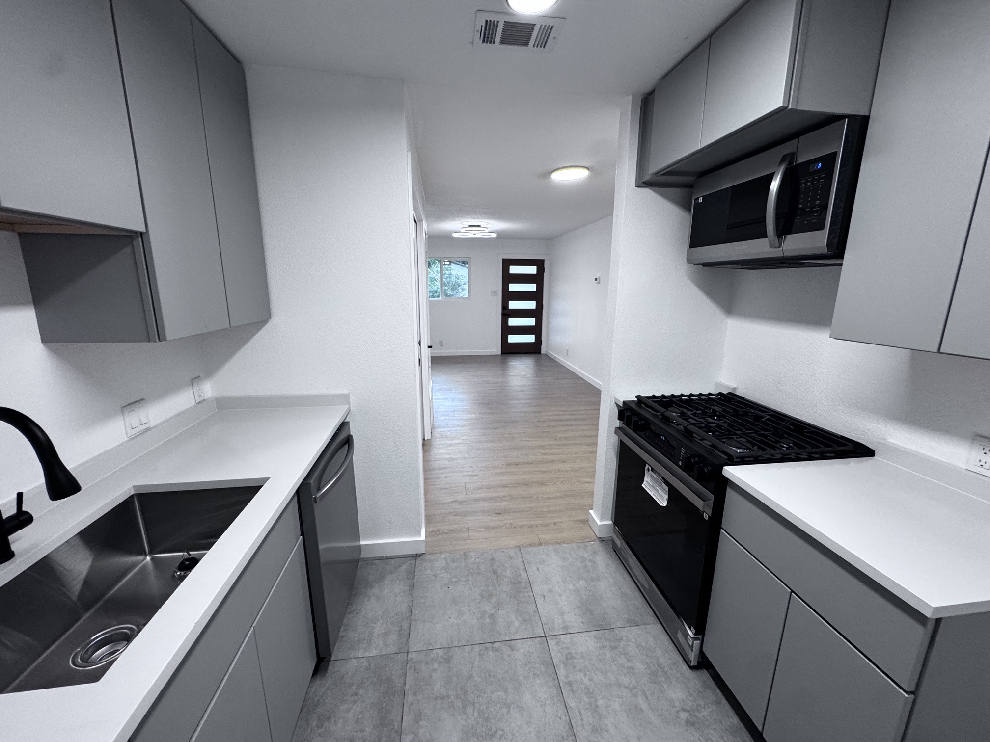 4908 Hawk Cove, Unit 2 Austin, TX 78745 - Photo 7 of 17 a kitchen with a stove and a microwave