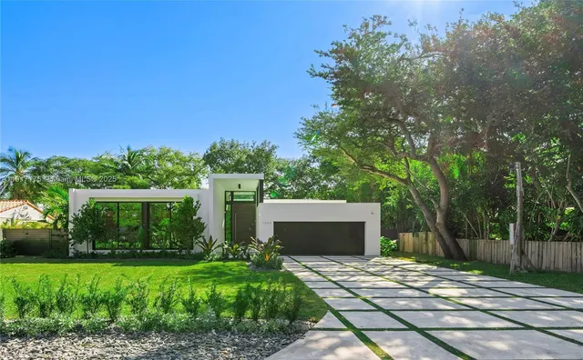a front view of a house with a garden