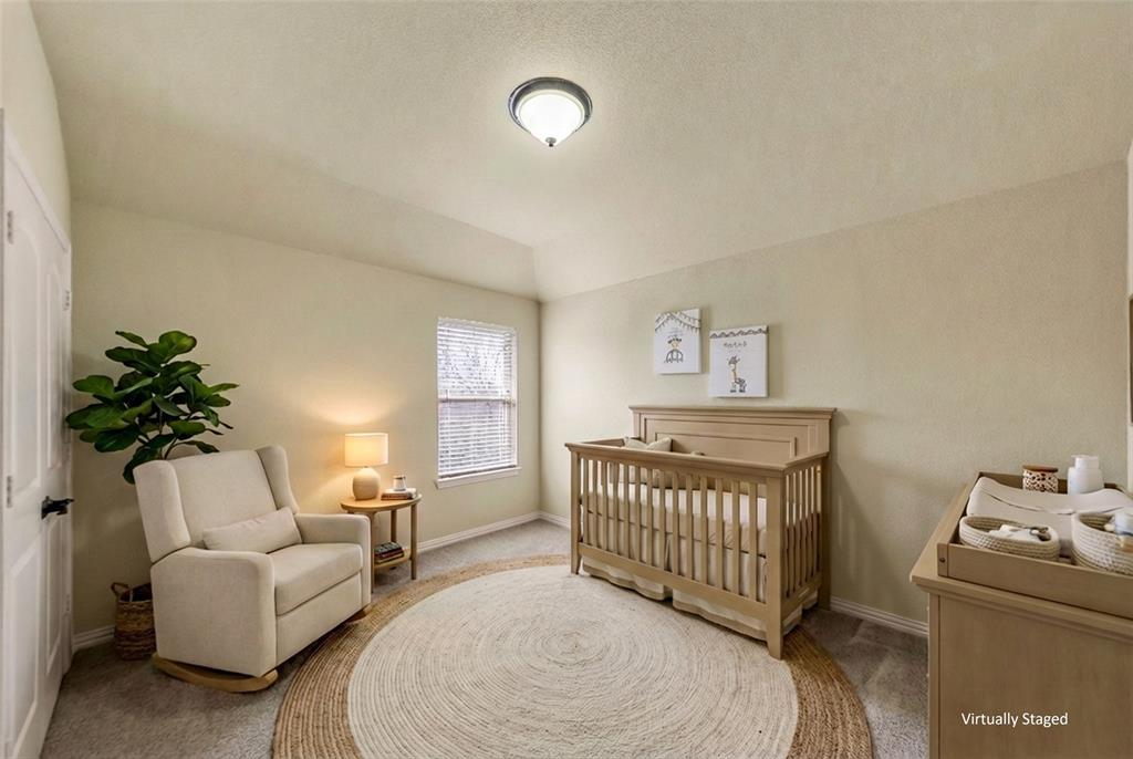 5143 Stream Crest Way Fairview, TX 75069 - Photo 28 of 35 Bedroom 3. Bedroom featuring a crib, light carpet, and lofted ceiling