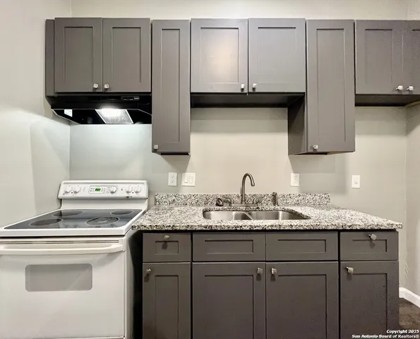a kitchen with a sink and cabinets