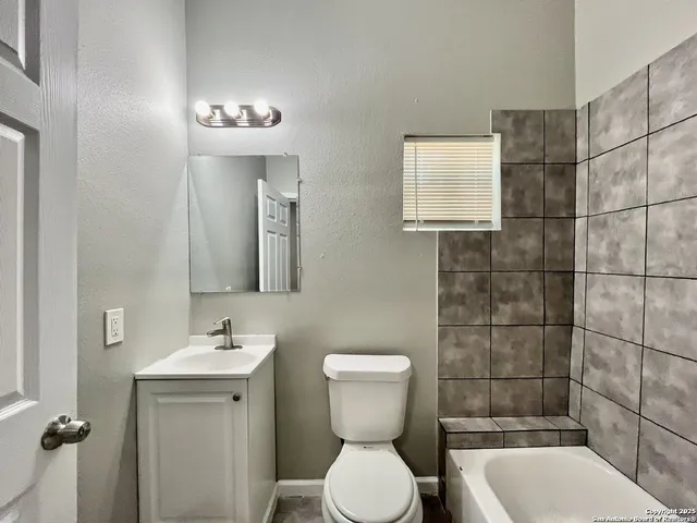 a bathroom with a toilet sink and shower