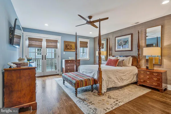 a bedroom with a large bed and a flat tv screen