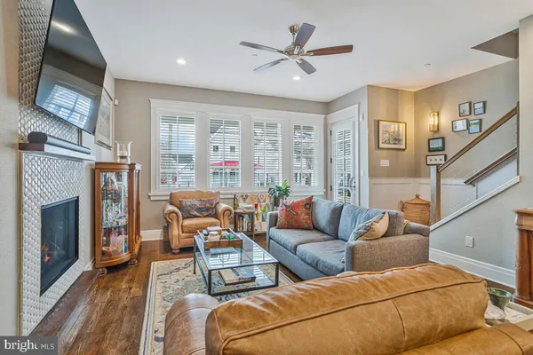 a living room with furniture and wooden floor