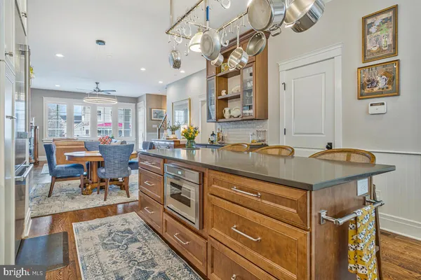 a kitchen with stainless steel appliances granite countertop a sink refrigerator and cabinets