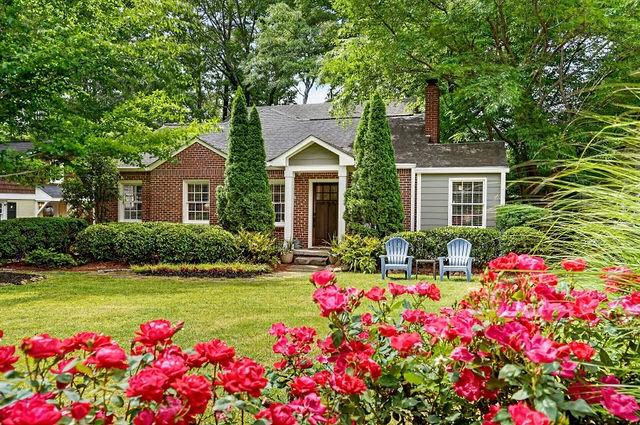 a front view of house with yard and flowers