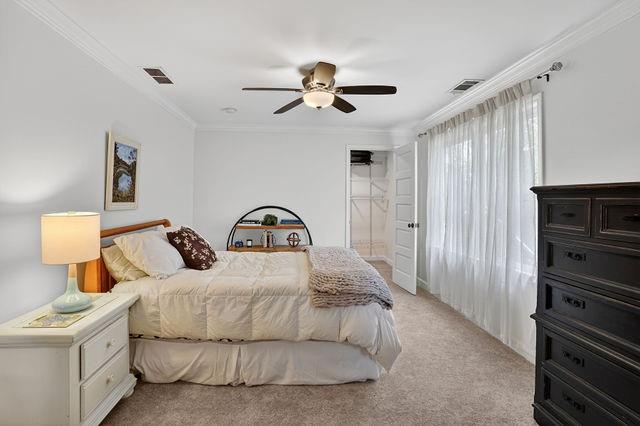 123 Mimosa Place Decatur, GA 30030 - Photo 27 of 48 a bedroom with a bed and a chandelier