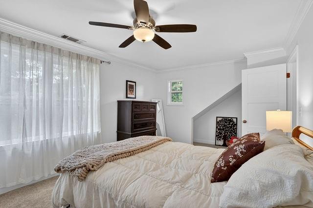 123 Mimosa Place Decatur, GA 30030 - Photo 28 of 48 a bedroom with a large bed and a chandelier