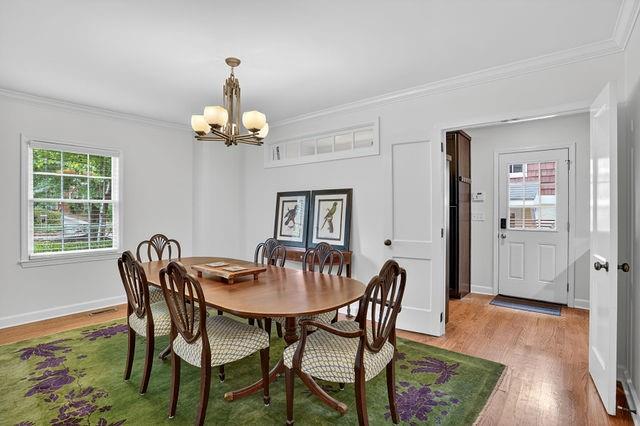 123 Mimosa Place Decatur, GA 30030 - Photo 6 of 48 a dining room with wooden floor a chandelier a wooden table and chairs