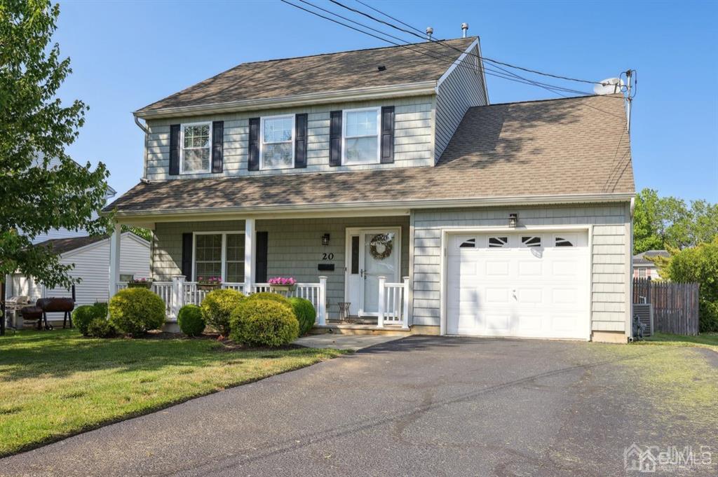 a front view of a house with a garden and garage
