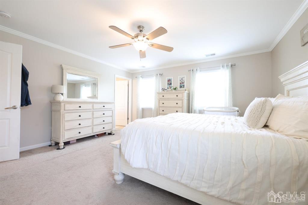20 Strachan Street Cliffwood, NJ 07721 - Photo 11 of 21 a spacious bedroom with a bed and a chandelier