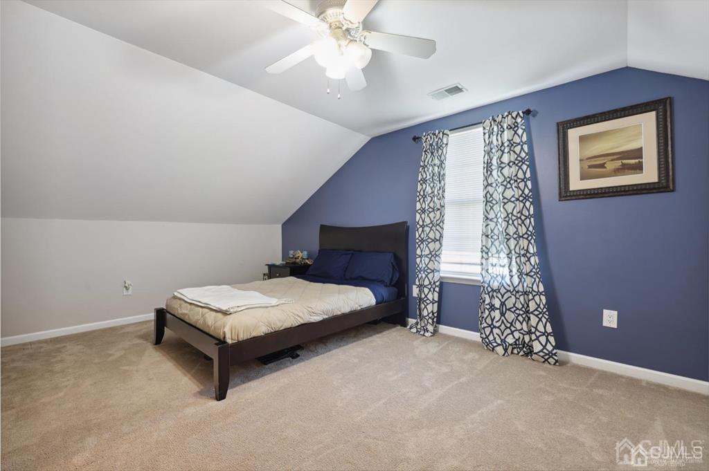 20 Strachan Street Cliffwood, NJ 07721 - Photo 15 of 21 a spacious bedroom with a bed and a chandelier