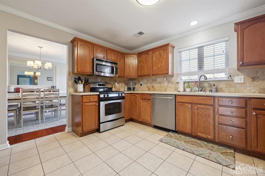 20 Strachan Street Cliffwood, NJ 07721 - Photo 5 of 21 a kitchen with stainless steel appliances granite countertop a stove sink and cabinets
