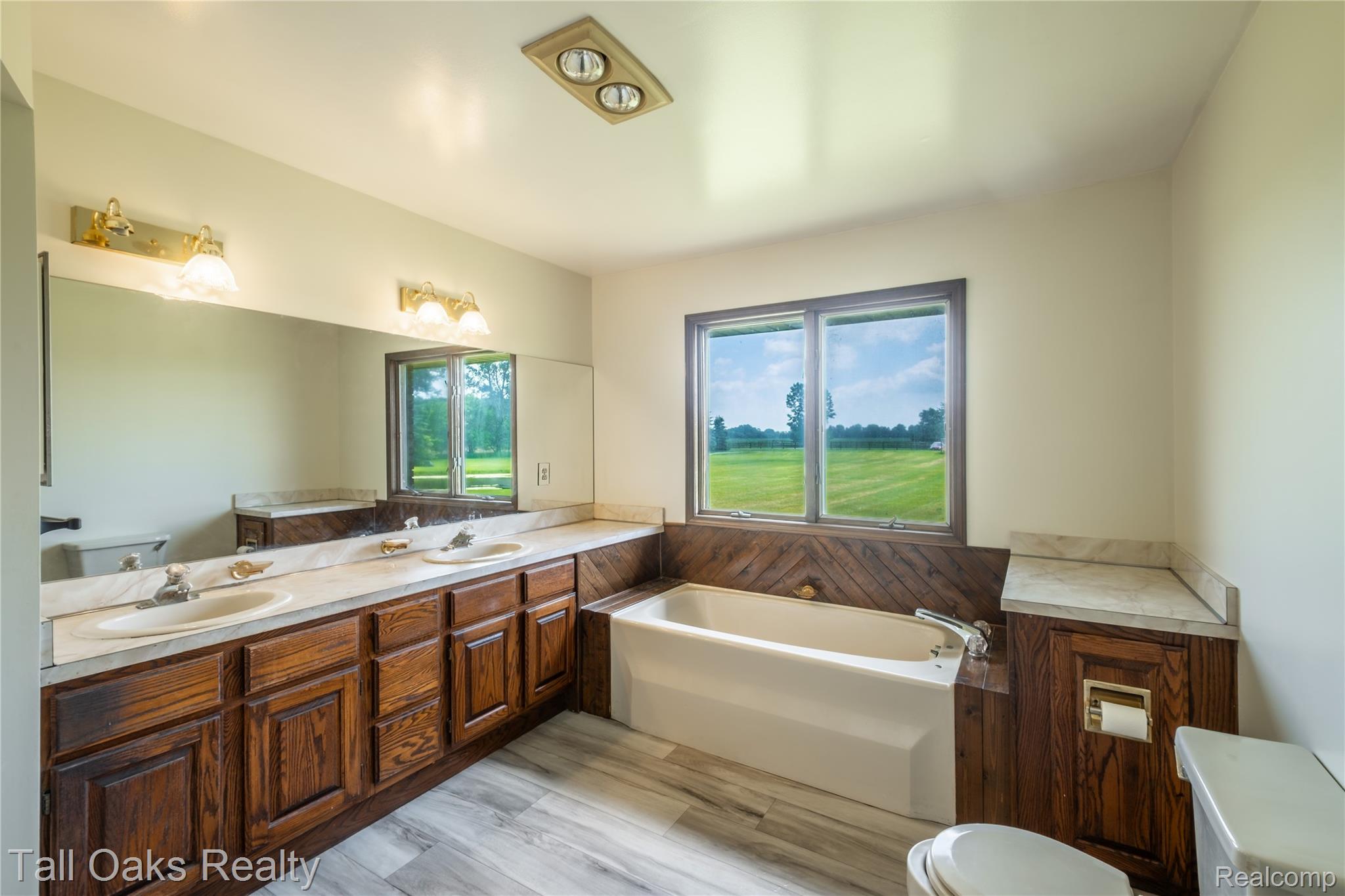 79330 Capac Road Armada, MI 48005 - Photo 33 of 42 Dual vanity with wood-finish cabinetry and light-toned countertops