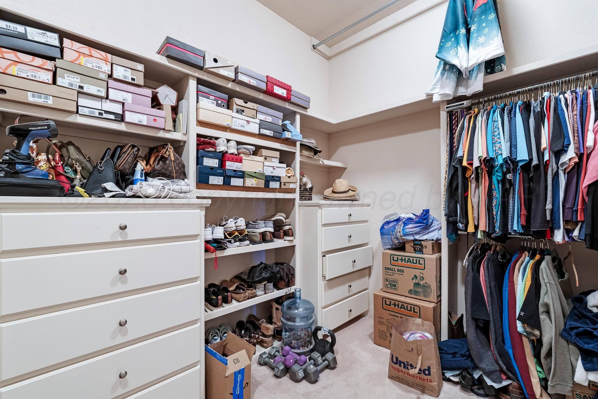 5008 Wesley Road Amarillo, TX 79119 - Photo 23 of 47 a view of walk in closet with clothes and shoes