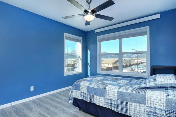 a bedroom with a large bed and a large window