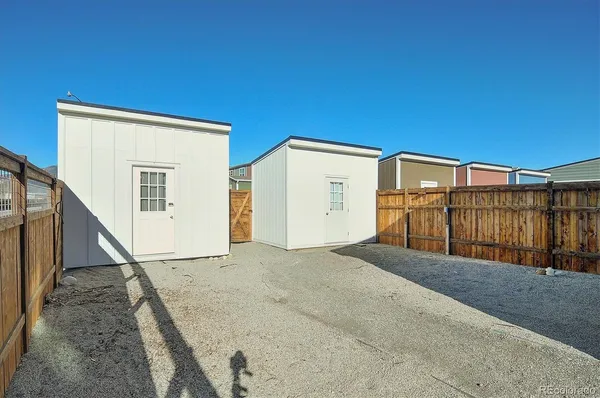 a view of a house with wooden fence