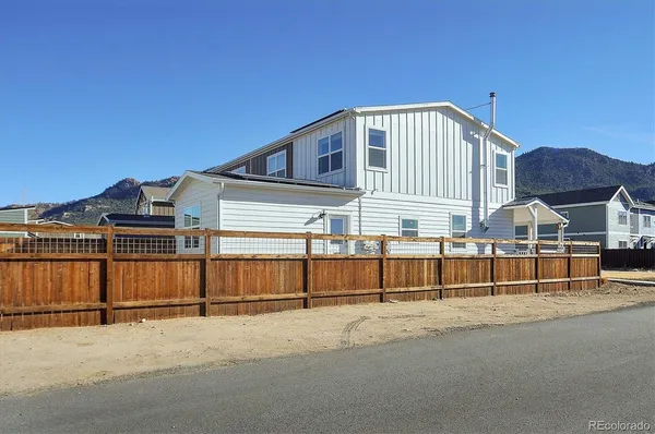 a view of a house with a wooden fence