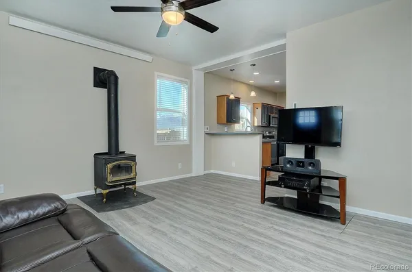 a view of a workspace with furniture and wooden floor