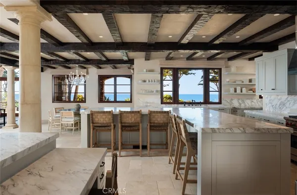 a white kitchen with granite countertop stainless steel appliances