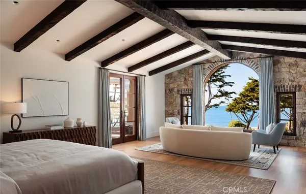 a bedroom with a bed couch and window
