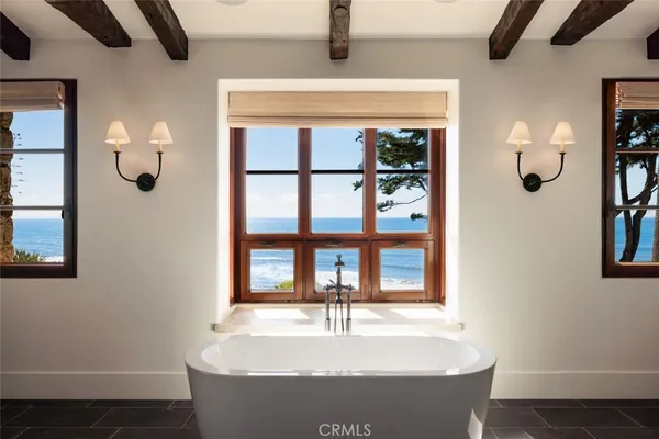 a bedroom with a bed and a large mirror