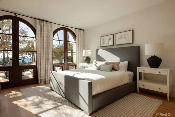 a view of a patio with couches table and chairs and potted plants