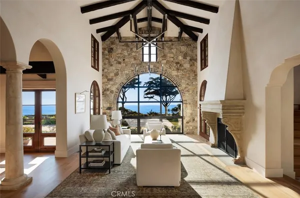 a living room with furniture and a mirror