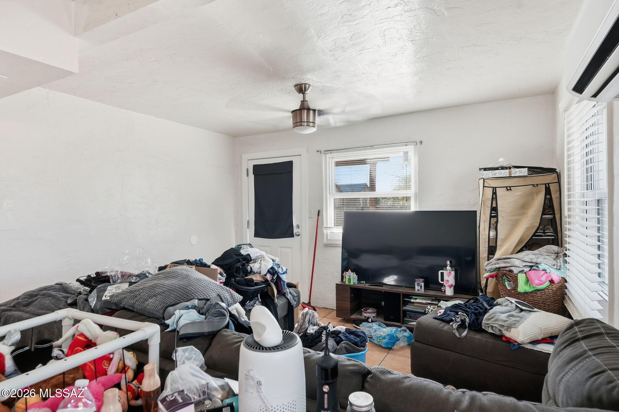 426 East Aragon Road, Unit 1 Tucson, AZ 85756 - Photo 5 of 18 a living room with furniture a flat screen tv and a fireplace