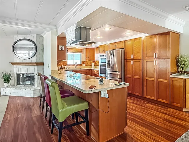 a dining room with furniture a large window and wooden floor