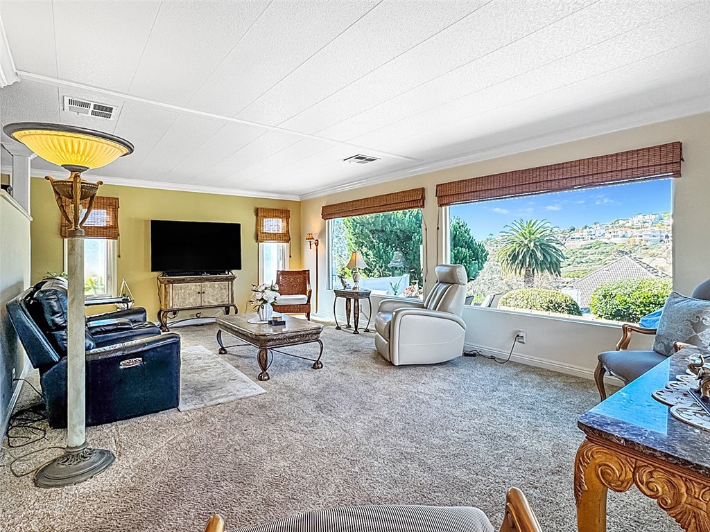 26 Mira Las Olas San Clemente, CA 92673 - Photo 17 of 34 a living room with furniture and a flat screen tv