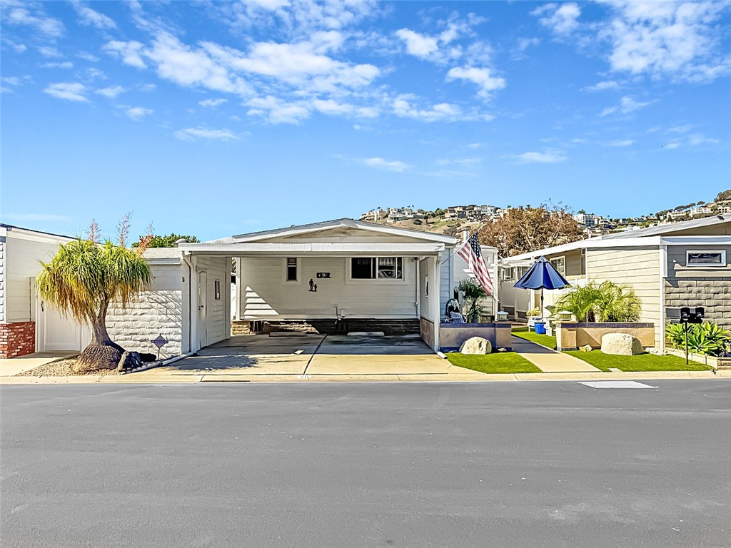 26 Mira Las Olas San Clemente, CA 92673 - Photo 2 of 34 a view of a house with pool and chairs next to a yard